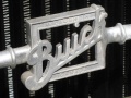 A grille ornament combines the American script with the Canadian name