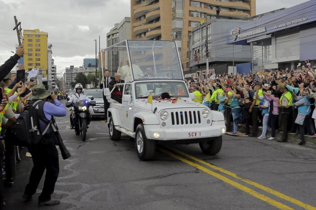 Pope Francis greets a crowd of the faithful from the Popemobile in Quito, Ecuador, July 5, 2015. Pope Francis landed in Ecuador's capital Quito on Sunday to begin an eight-day tour of South America that will also include visits to Bolivia and Paraguay. On his first visit as pontiff to Spanish-speaking Latin America, the Argentina-born pope is scheduled to conduct masses in both Quito and the coastal city of Guayaquil before flying to Bolivia on Wednesday.  REUTERS/Gary Granja